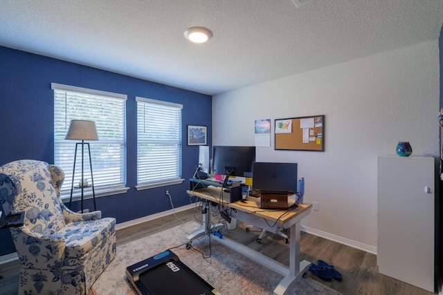 office area with wood finished floors, baseboards, and a textured ceiling