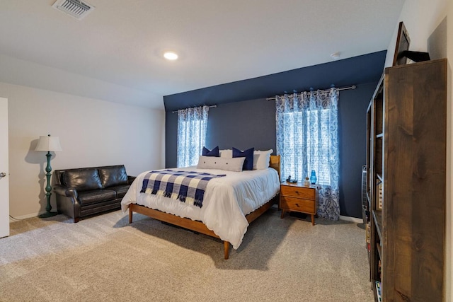 bedroom featuring visible vents, multiple windows, and carpet flooring