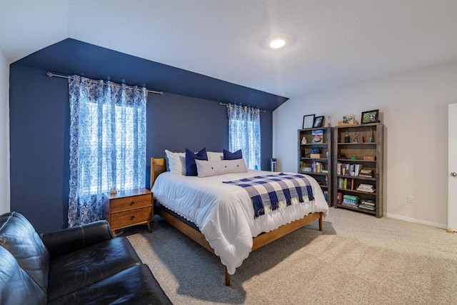 bedroom featuring baseboards, carpet, and vaulted ceiling