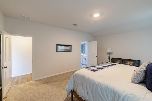 bedroom featuring visible vents, baseboards, carpet, and vaulted ceiling