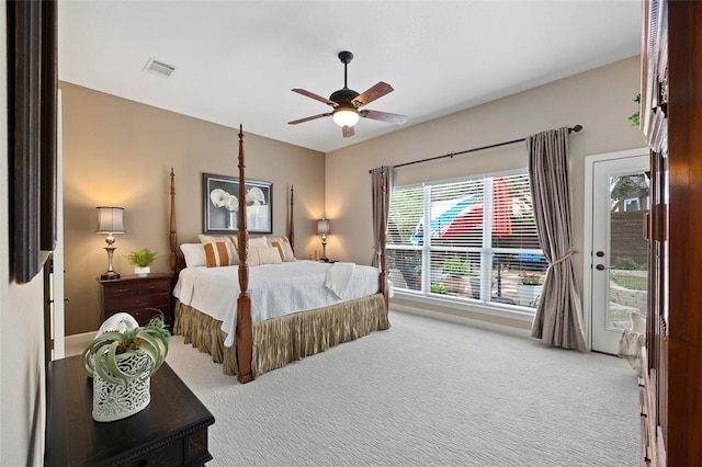 bedroom with a ceiling fan, access to exterior, visible vents, and carpet