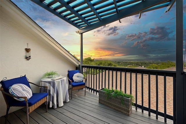 deck at dusk featuring a pergola