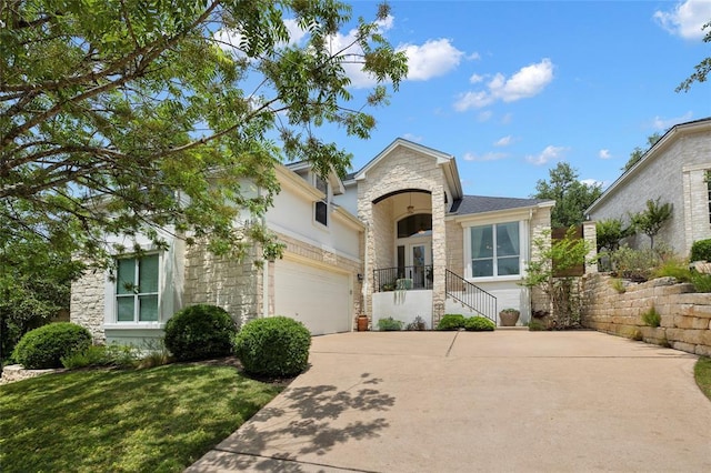 view of front of property with stone siding and driveway