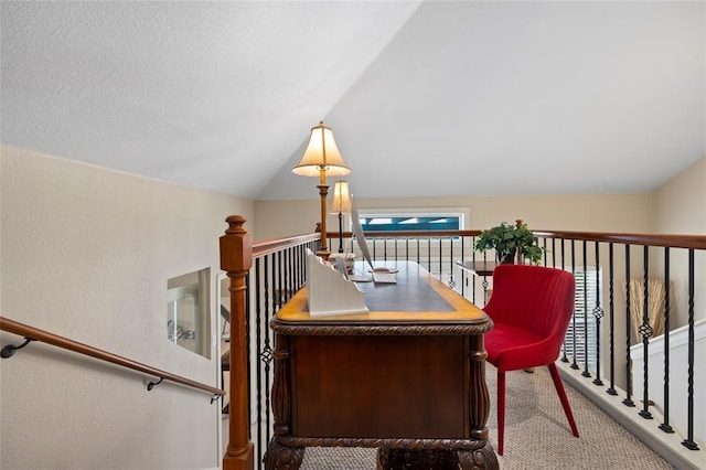 carpeted home office with lofted ceiling