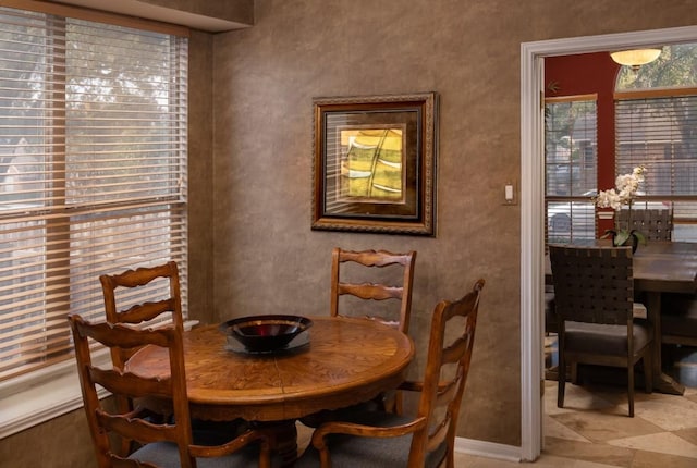 dining space featuring baseboards