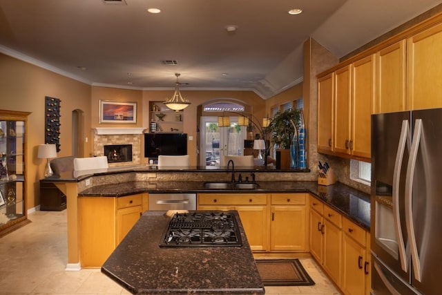 kitchen with a sink, stainless steel appliances, a peninsula, and crown molding