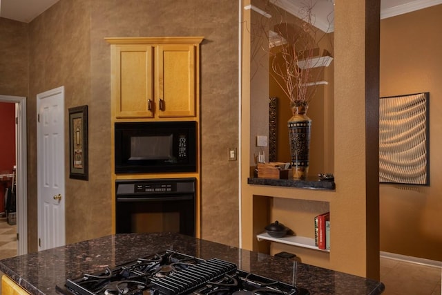 kitchen featuring light brown cabinets, baseboards, dark stone counters, black appliances, and crown molding