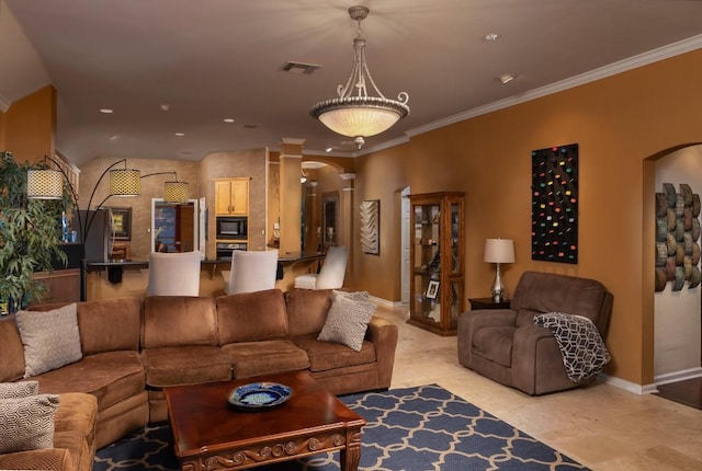 living area with visible vents, arched walkways, baseboards, and ornamental molding