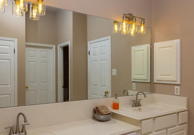 full bathroom with vanity and a chandelier