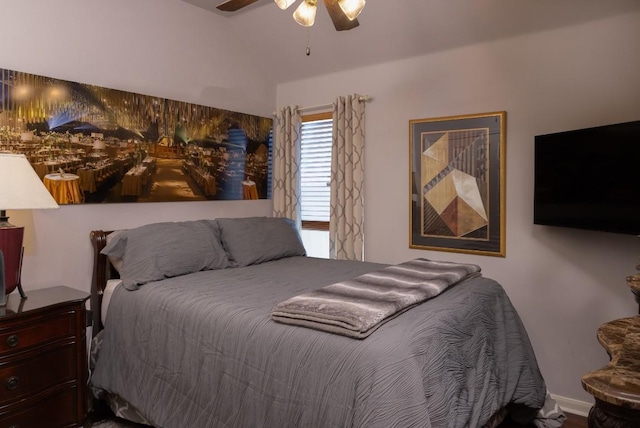 bedroom featuring a ceiling fan and lofted ceiling