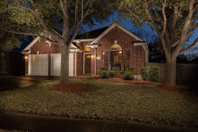 single story home with a garage, brick siding, concrete driveway, and fence