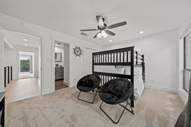 carpeted bedroom featuring visible vents, baseboards, recessed lighting, ensuite bath, and a ceiling fan