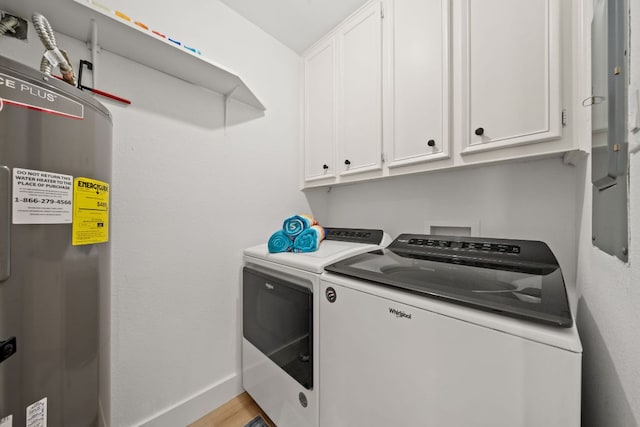 laundry area featuring light wood finished floors, baseboards, washer and clothes dryer, water heater, and cabinet space