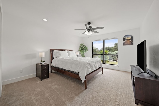 bedroom with a ceiling fan, recessed lighting, light colored carpet, and baseboards