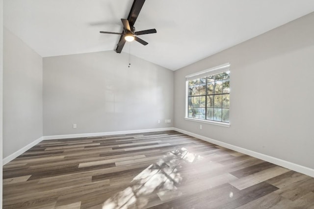 unfurnished room with wood finished floors, baseboards, ceiling fan, and vaulted ceiling with beams