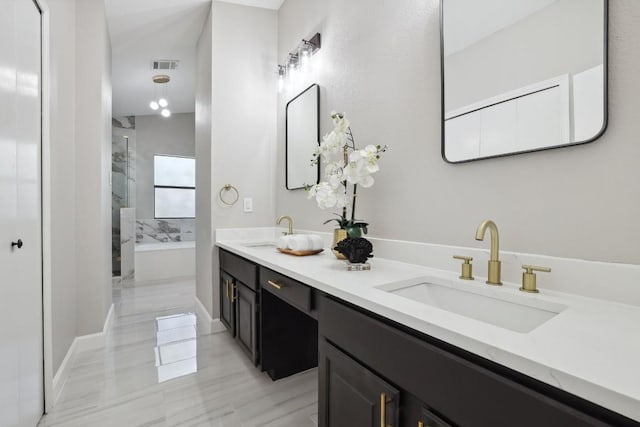 full bathroom with double vanity, a bath, visible vents, and a sink