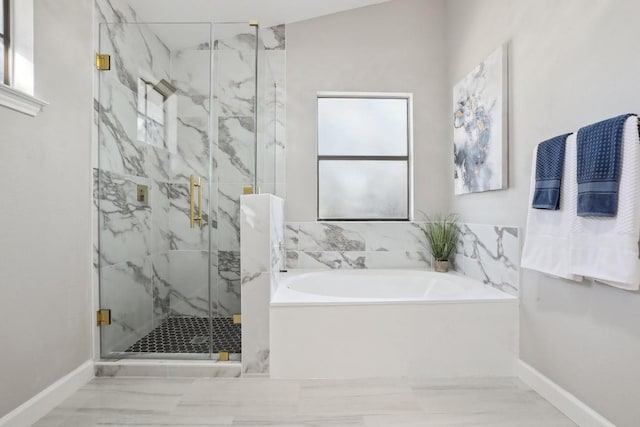 full bath featuring a marble finish shower, marble finish floor, baseboards, and a garden tub