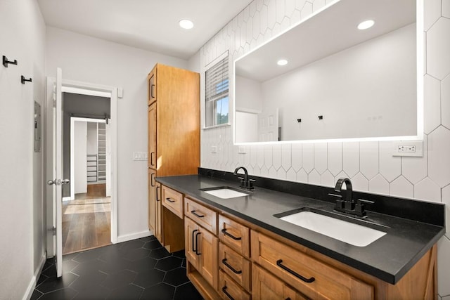 bathroom with tile patterned floors, recessed lighting, double vanity, and a sink