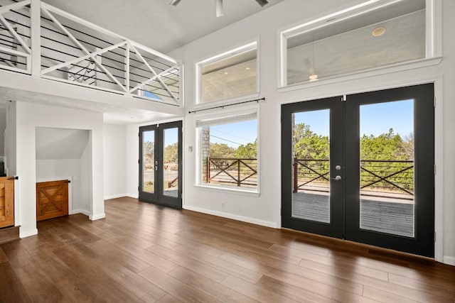 interior space featuring french doors, baseboards, and wood finished floors