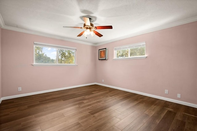 empty room with ornamental molding, baseboards, ceiling fan, and wood finished floors