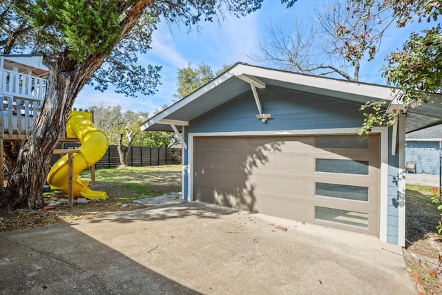 detached garage featuring fence