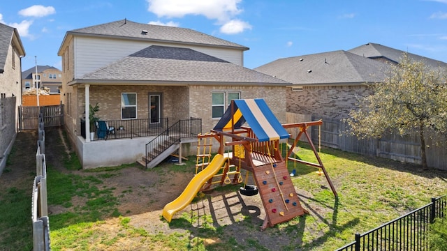 rear view of house with a playground, a fenced backyard, brick siding, and a shingled roof