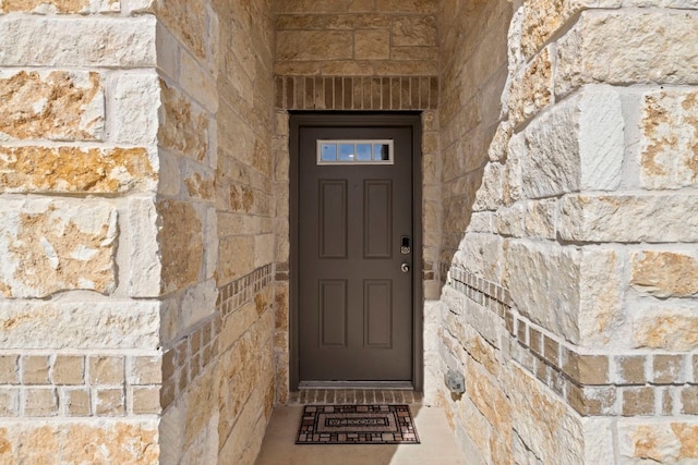 property entrance with stone siding