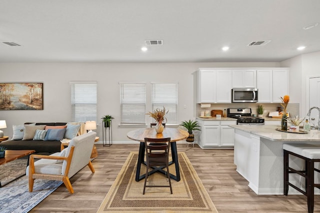 kitchen with visible vents, stainless steel appliances, and light wood-type flooring