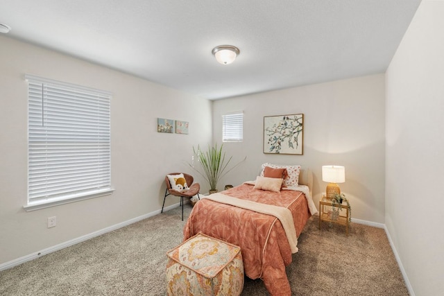 bedroom with baseboards and carpet