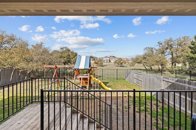 view of play area featuring a lawn and a fenced backyard