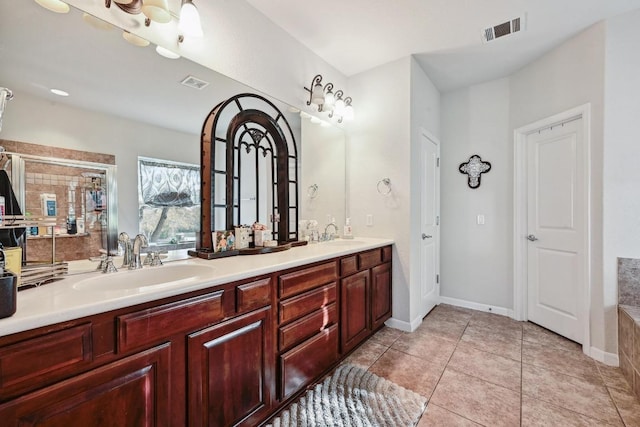 bathroom featuring a sink, visible vents, and tile patterned floors