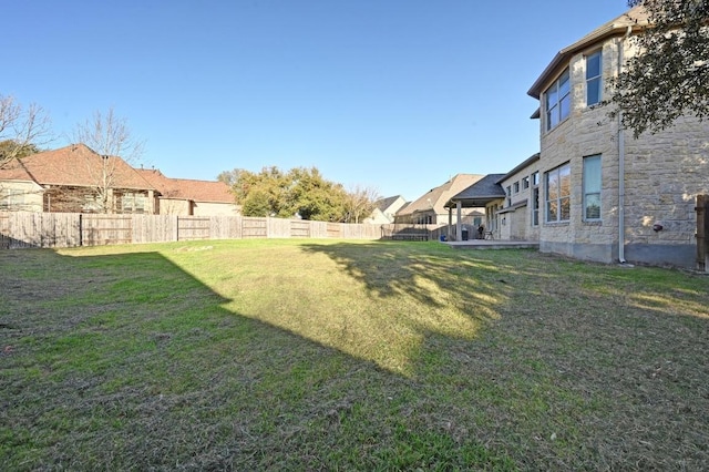 view of yard featuring fence and a residential view