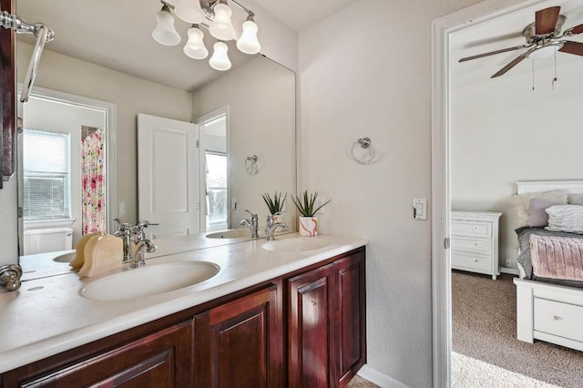 bathroom with double vanity, ceiling fan with notable chandelier, and a sink