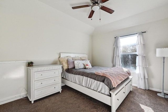 bedroom featuring ceiling fan, baseboards, lofted ceiling, and dark colored carpet