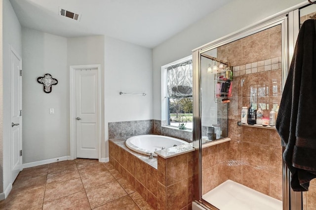 bathroom featuring tile patterned floors, visible vents, a garden tub, a shower stall, and baseboards