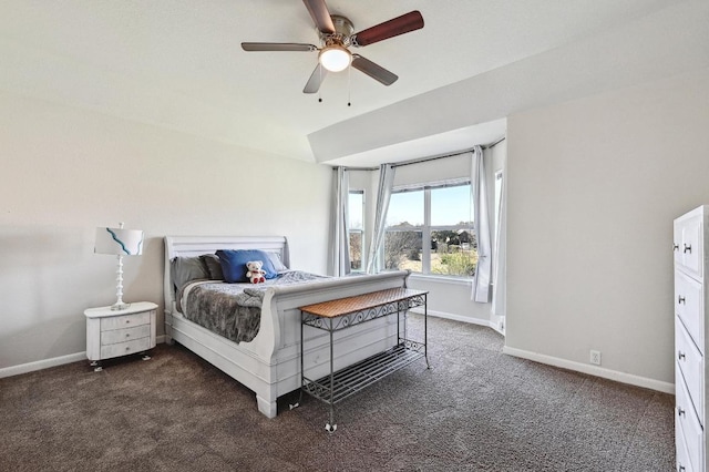 bedroom featuring baseboards, dark colored carpet, and ceiling fan