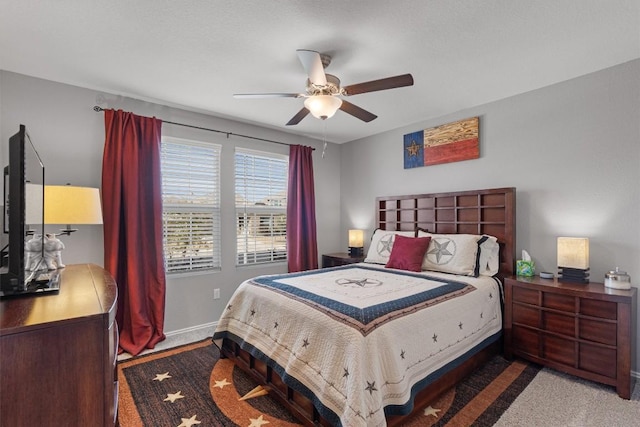 carpeted bedroom featuring a ceiling fan and baseboards