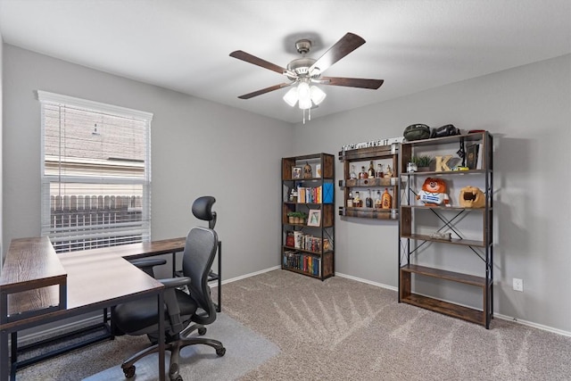 office area featuring carpet flooring, baseboards, and ceiling fan