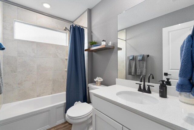 full bathroom featuring shower / tub combo, toilet, wood finished floors, and vanity