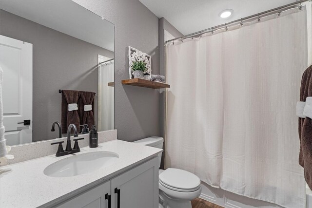 full bath with toilet, vanity, and shower / tub combo