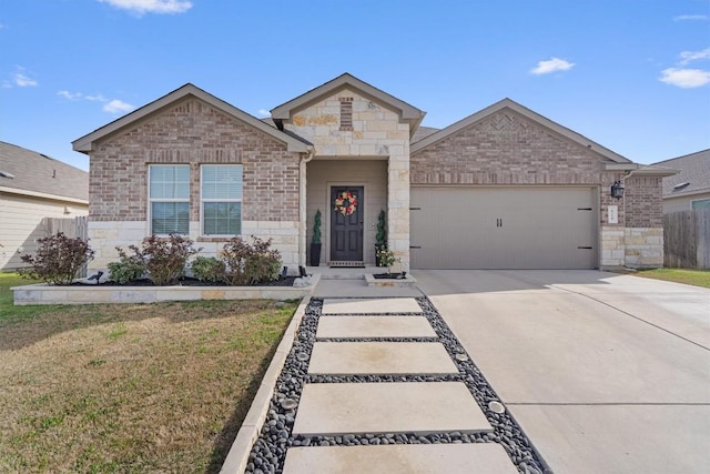 view of front of house with fence, driveway, a front lawn, a garage, and stone siding