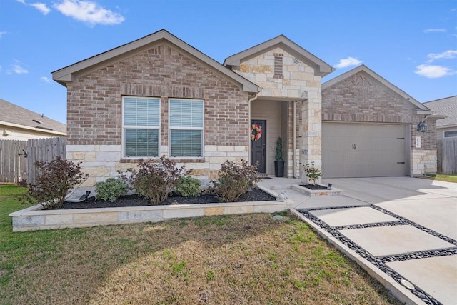 view of front facade with concrete driveway, a garage, fence, and stone siding