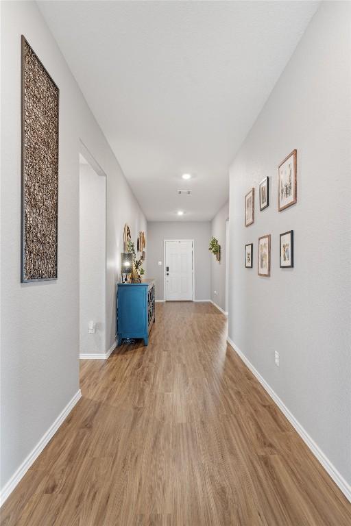 interior space with wood finished floors and baseboards