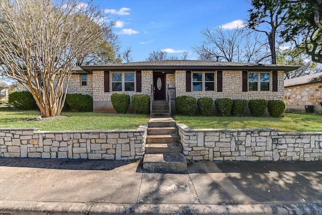 single story home with stone siding and a front yard