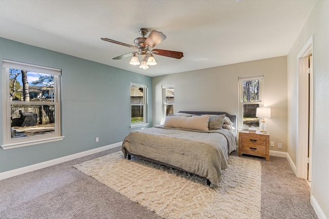 bedroom featuring a ceiling fan, carpet, and baseboards