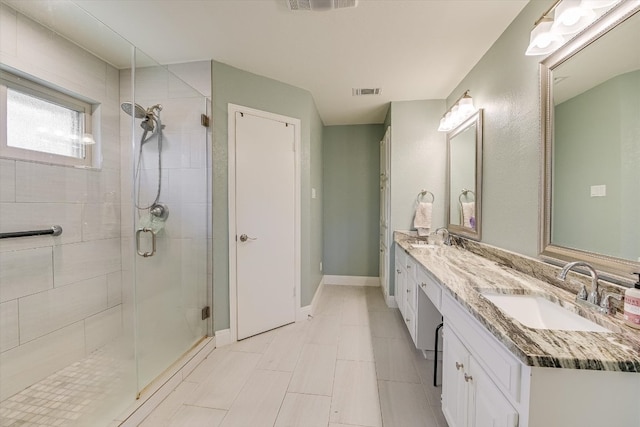 full bath featuring a sink, visible vents, and a shower stall