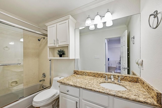 bathroom featuring combined bath / shower with glass door, vanity, crown molding, and toilet