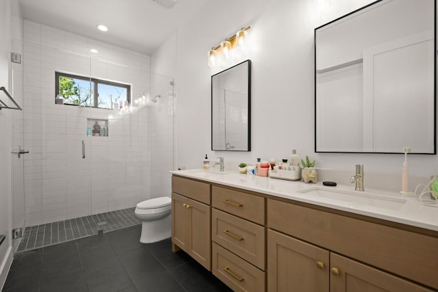 bathroom featuring tile patterned floors, a stall shower, toilet, and a sink