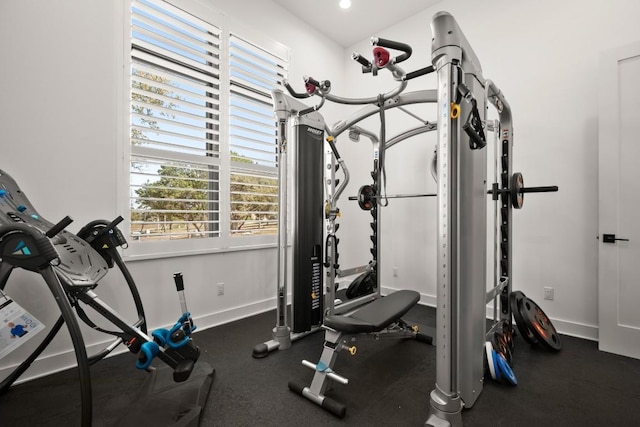 exercise room with recessed lighting and baseboards