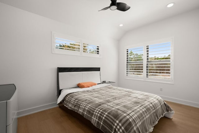 bedroom with lofted ceiling, baseboards, and wood finished floors